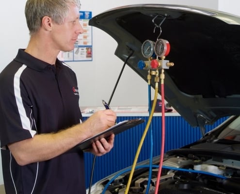 man-inspecting-cooling-system