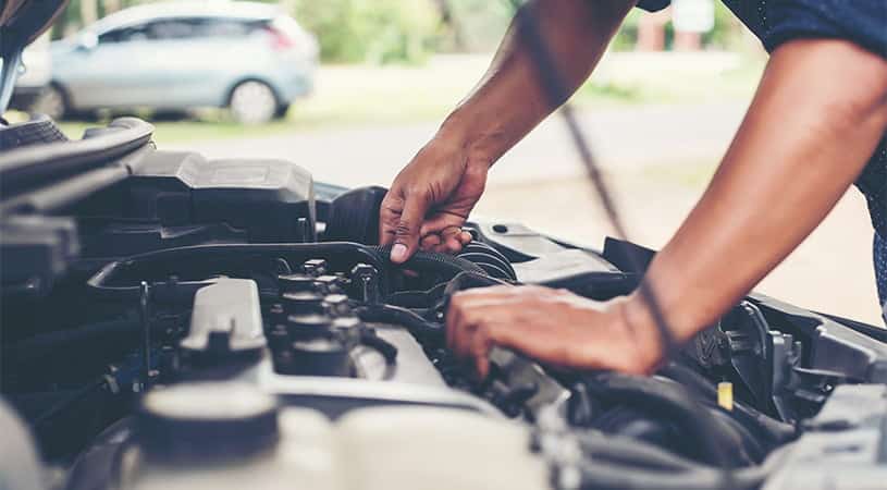 mechanic checking for aircon compressor issues