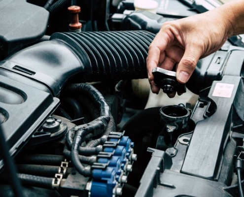 man checking a car radiator
