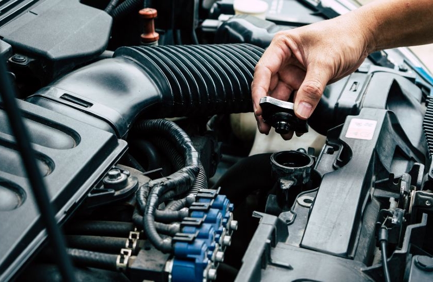 man checking a car radiator