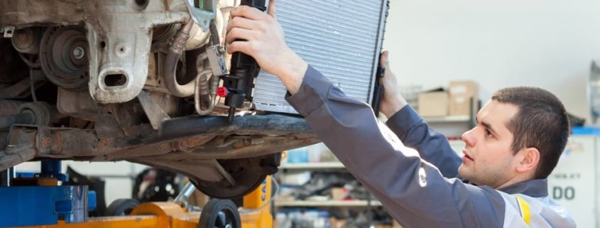 mechanic changing radiator