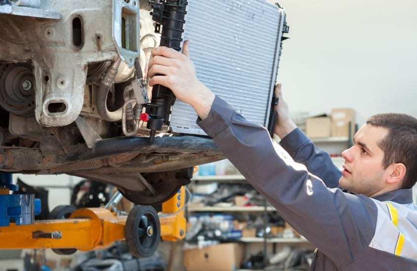mechanic changing radiator