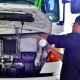 truck driver refilling water in truck radiator