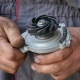 mechanic handling a water pump