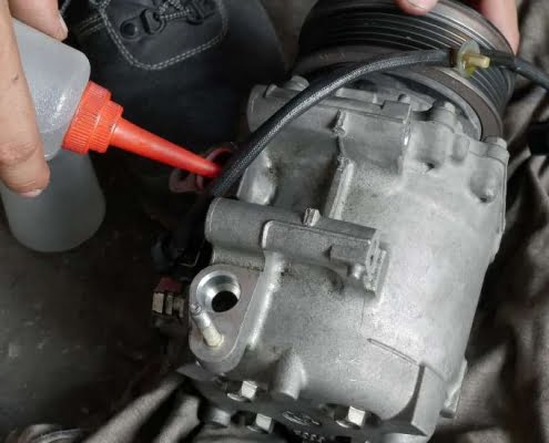 auto mechanic checking car air conditioner