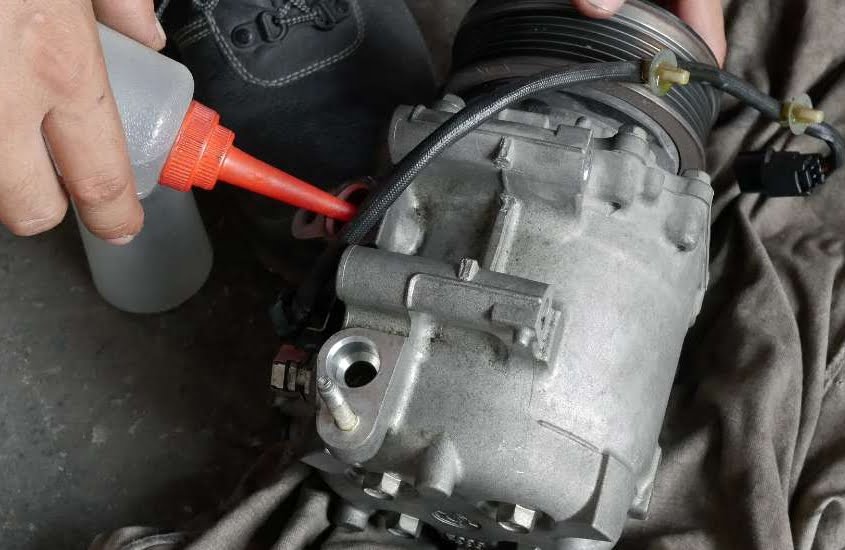 auto mechanic checking car air conditioner