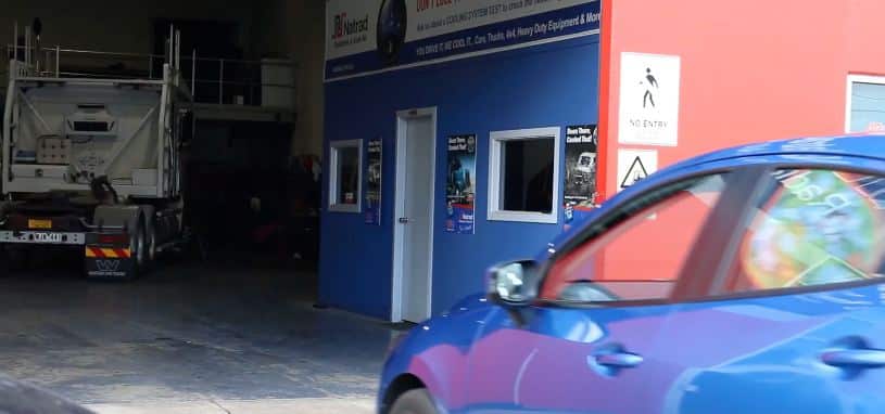 A car pulling into a Natrad workshop.