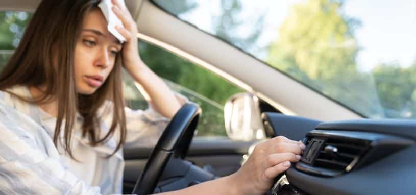 woman fixing car air conditioning vent